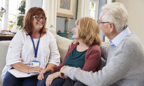 Female Support Worker Visits Senior Couple At Home